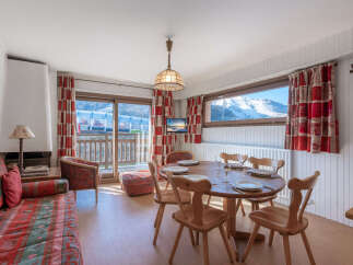 This charming property boasts a cozy living space with a fireplace and a dining area perfect for gatherings.