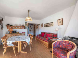 This charming living space features a cozy seating area with a comfortable sofa and a unique armchair.