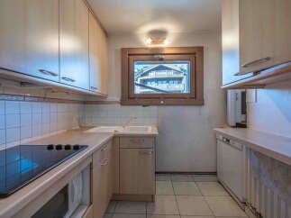 This charming kitchen offers a cozy and functional space, perfect for preparing meals.