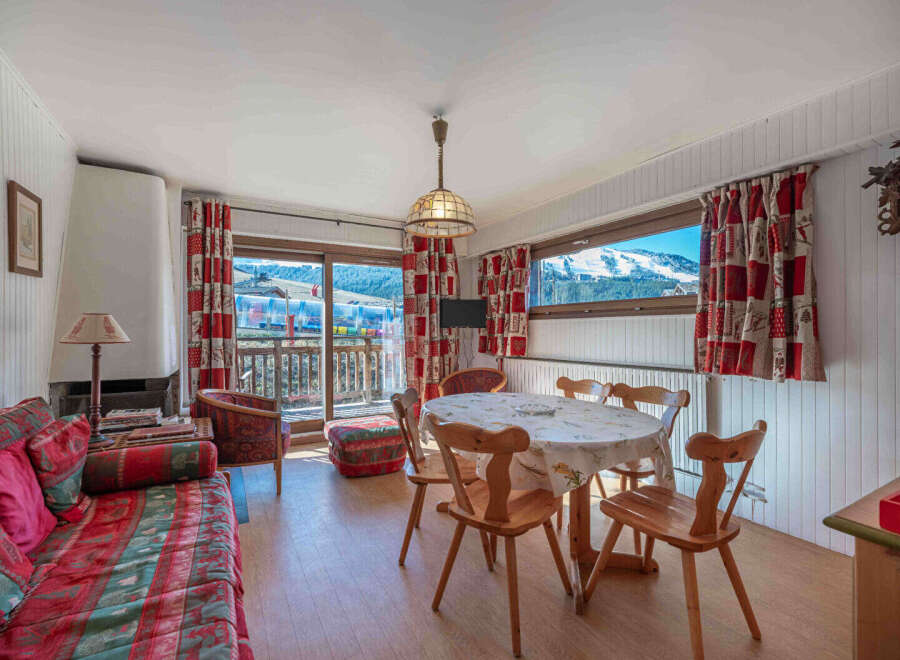Experience the charm of this cozy apartment, featuring a bright living space with a fireplace and a dining area.