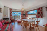 Experience the charm of this cozy apartment, featuring a bright living space with a fireplace and a dining area.