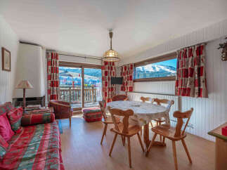 Experience the charm of this cozy apartment, featuring a bright living space with a fireplace and a dining area.