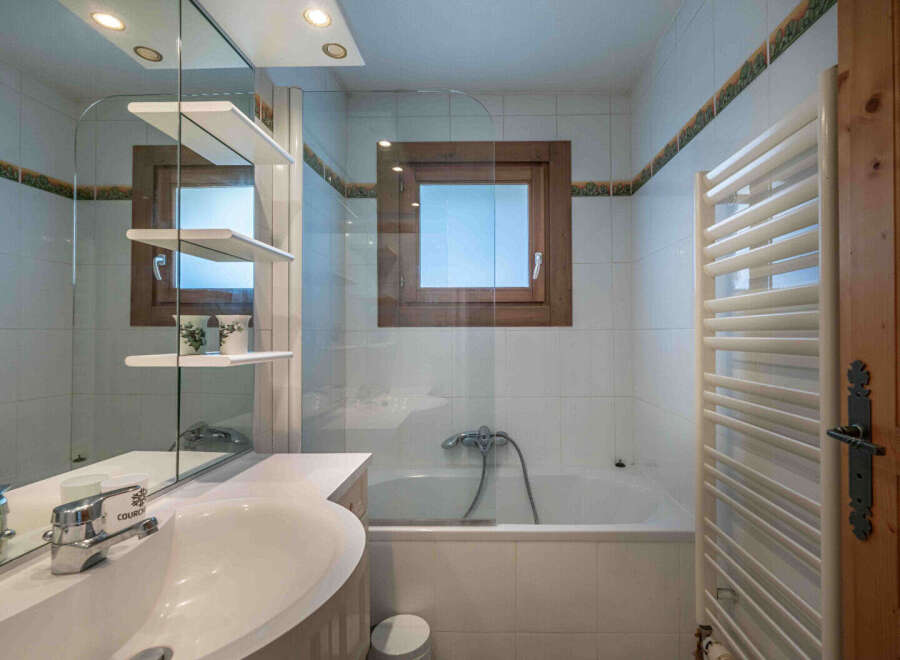 This charming bathroom features a bright and airy design, perfect for relaxation.