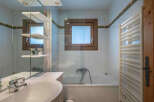 This charming bathroom features a bright and airy design, perfect for relaxation.