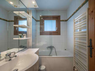 This charming bathroom features a bright and airy design, perfect for relaxation.