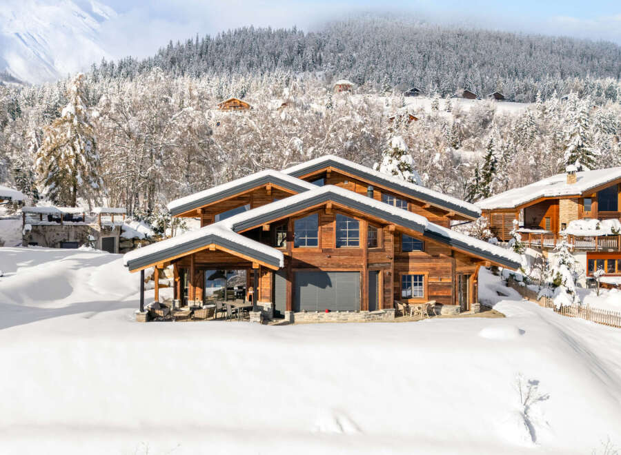 Experience the epitome of luxury living in this stunning chalet nestled amidst a winter wonderland.