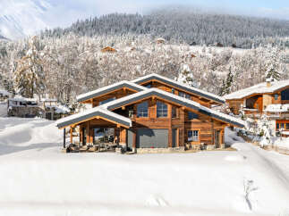 Experience the epitome of luxury living in this stunning chalet nestled amidst a winter wonderland.