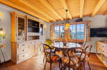 Experience the charm of this exquisite dining room, featuring a rustic wooden table and chairs, perfect for intimate gatherings.