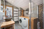 Discover the charm of this unique bathroom design, featuring a rustic wooden countertop and a stylish stone sink.