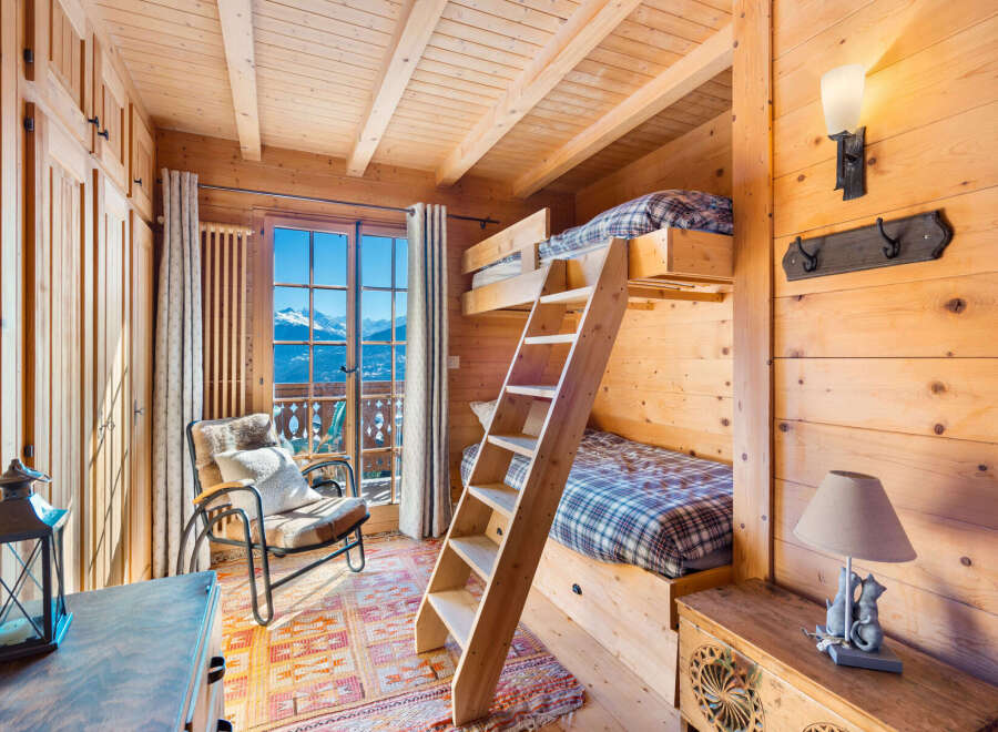 Experience the charm of this cozy cabin bedroom, perfect for a mountain getaway.