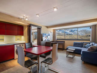 Experience the ultimate mountain retreat in this stunning apartment! Featuring a modern kitchen, a cozy living area with a comfortable sofa, and a dining table, this space is perfect for relaxation.