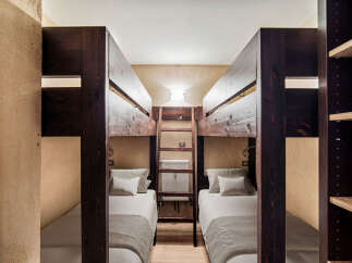 This cozy bedroom features two sets of bunk beds, perfect for accommodating multiple guests or family members.