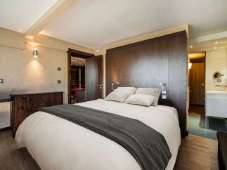 Discover the epitome of luxury in this stunning bedroom, featuring a plush bed and elegant design.
