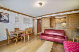 Discover the charm of this inviting property, featuring a cozy living space with a stylish red sofa.