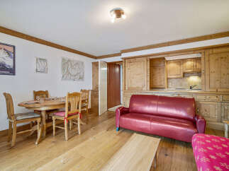 Discover the charm of this inviting property, featuring a cozy living space with a stylish red sofa.