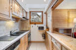 This charming kitchen boasts a warm, inviting ambiance with its wooden cabinetry and countertops.