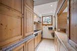 This charming kitchen features beautiful wooden cabinetry and countertops, creating a warm and inviting atmosphere.