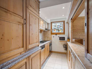 This charming kitchen features beautiful wooden cabinetry and countertops, creating a warm and inviting atmosphere.