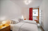 This cozy bedroom features two twin beds, perfect for guests or roommates.