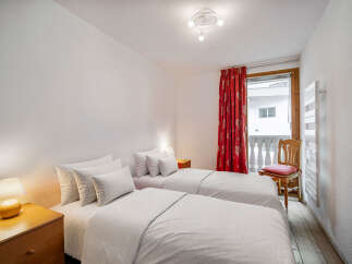 This cozy bedroom features two twin beds, perfect for guests or roommates.
