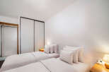 This cozy bedroom features two twin beds, perfect for guests or roommates.