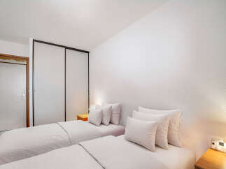This cozy bedroom features two twin beds, perfect for guests or roommates.