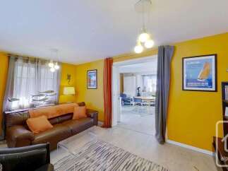 Discover this charming property featuring a cozy living room with a comfortable leather sofa and a stylish glass coffee table.
