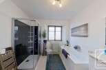 Step into this luxurious bathroom, featuring a sleek glass shower and a relaxing bathtub.