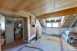 Discover the potential of this unique property! This space features exposed wooden beams, offering a rustic charm.