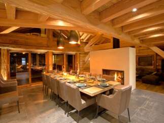 Experience luxury living in this stunning chalet, featuring a spacious dining area perfect for entertaining.
