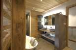 This luxurious bathroom boasts a rustic, yet modern design, perfect for a relaxing retreat.