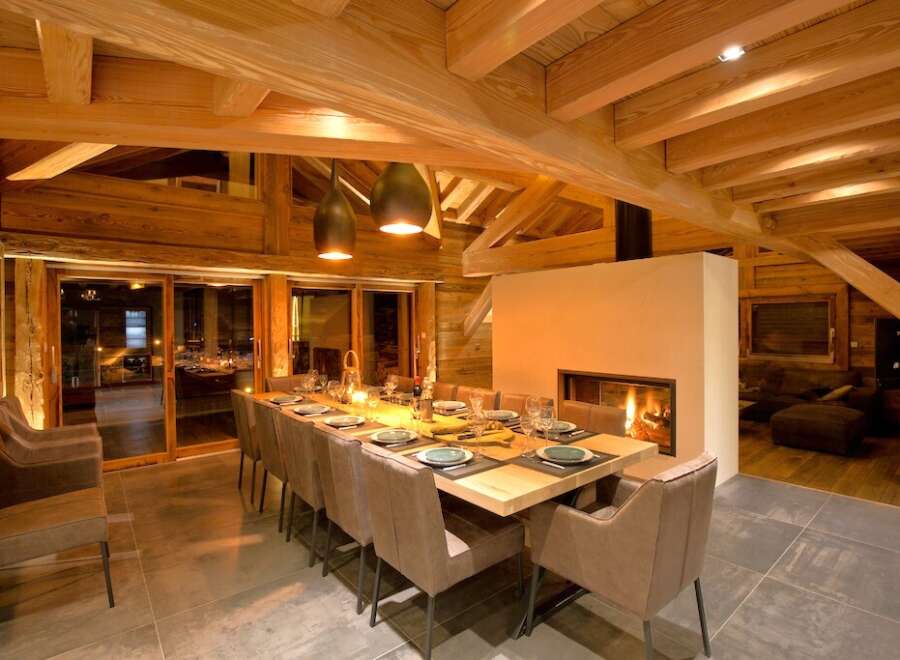 Experience luxury living in this stunning chalet, featuring a spacious dining area perfect for entertaining.