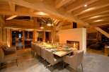 Experience luxury living in this stunning chalet, featuring a spacious dining area perfect for entertaining.