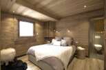 This cozy bedroom features a rustic wooden design, creating a warm and inviting atmosphere.