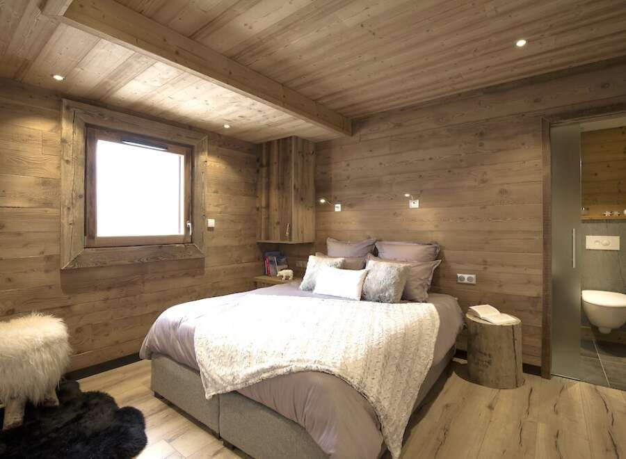 This cozy bedroom features a rustic wooden design, creating a warm and inviting atmosphere.