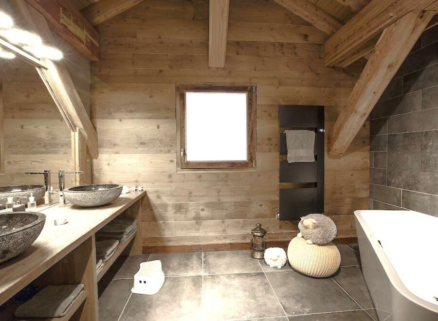 This stunning bathroom boasts a rustic charm with its wooden walls and exposed beams, creating a warm and inviting atmosphere.