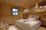 This cozy bedroom features a rustic wooden design, creating a warm and inviting atmosphere.