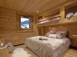 This cozy bedroom features a rustic wooden design, creating a warm and inviting atmosphere.
