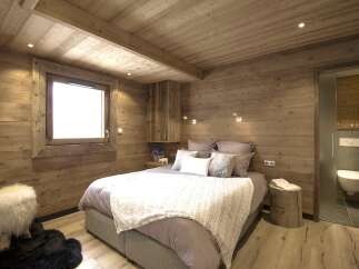 This cozy bedroom features a rustic wooden design, creating a warm and inviting atmosphere.