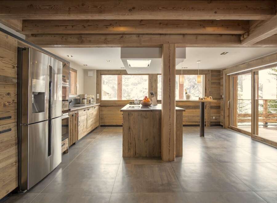 This stunning kitchen boasts a rustic, yet modern design, perfect for a luxurious mountain retreat.