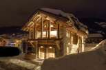 Experience the charm of this stunning wooden chalet nestled in a snowy landscape.