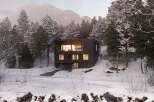 This stunning modern home is nestled in a serene, snow-covered forest, offering a perfect blend of luxury and nature.
