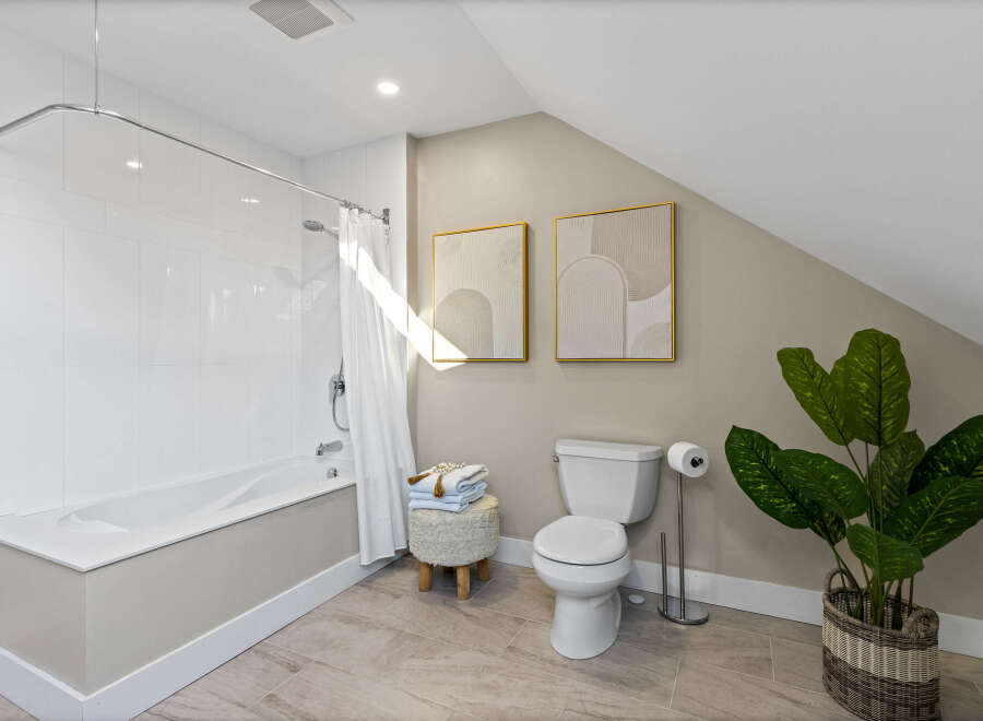 Step into this beautifully designed bathroom, featuring a modern bathtub and a sleek toilet.