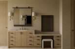 This luxurious bathroom features a modern vanity with ample storage and a sleek design.