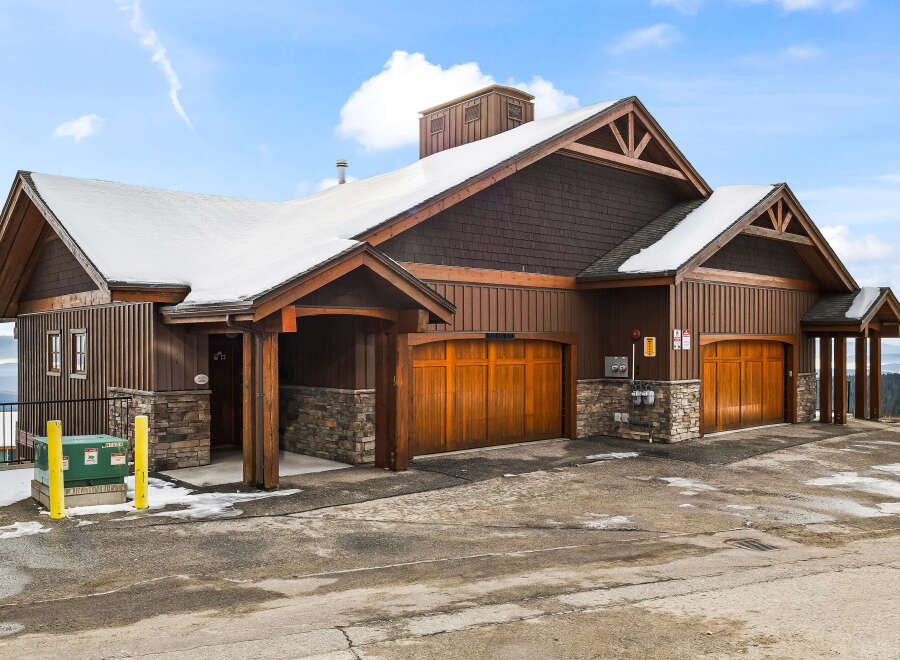 This stunning property boasts a beautiful exterior with a combination of wood and stone accents, creating a warm and inviting atmosphere.