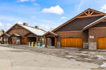 Discover a stunning property featuring beautiful wooden garage doors and a charming exterior design.
