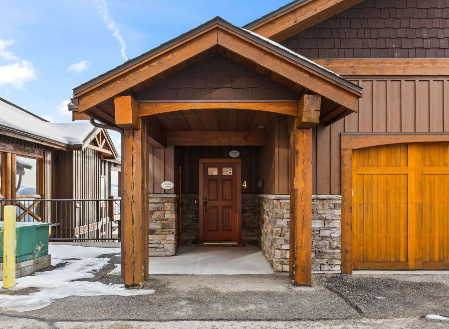 This stunning property boasts a beautiful wooden facade and a welcoming entrance.