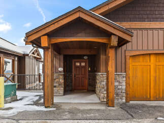 This stunning property boasts a beautiful wooden facade and a welcoming entrance.