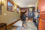 Step into luxury with this stunning entryway, featuring a unique stone floor and a grand mirror.