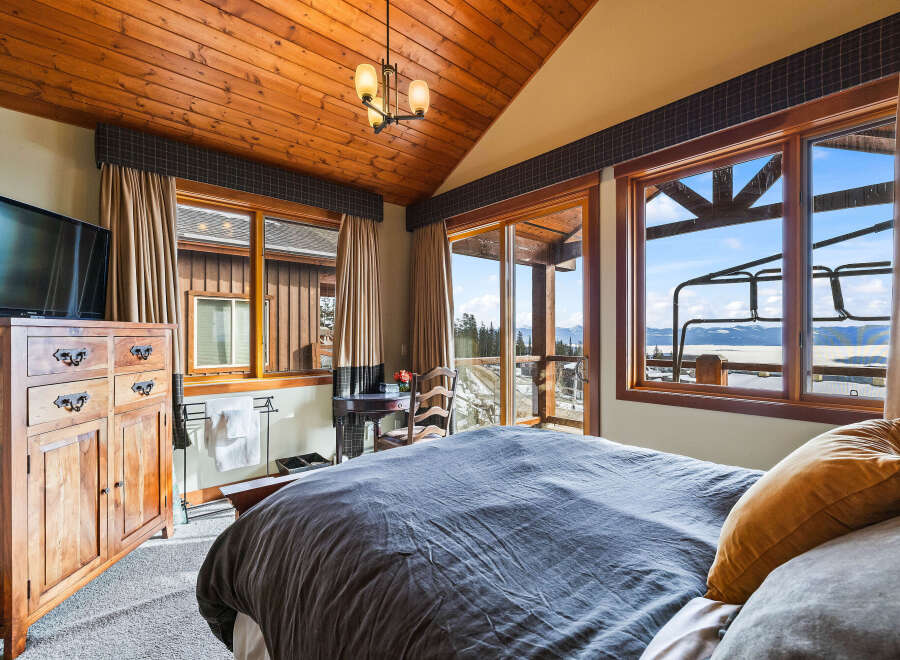 Experience luxury living in this stunning bedroom with breathtaking views.